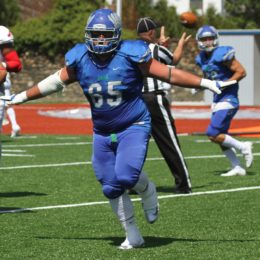 Senior Ian Bomely celebrates Seahawk style in their 26-20 win over Montclair State. This was the first time Salve Football played on Toppa Field in 8 years. Photo by Zan Carver.